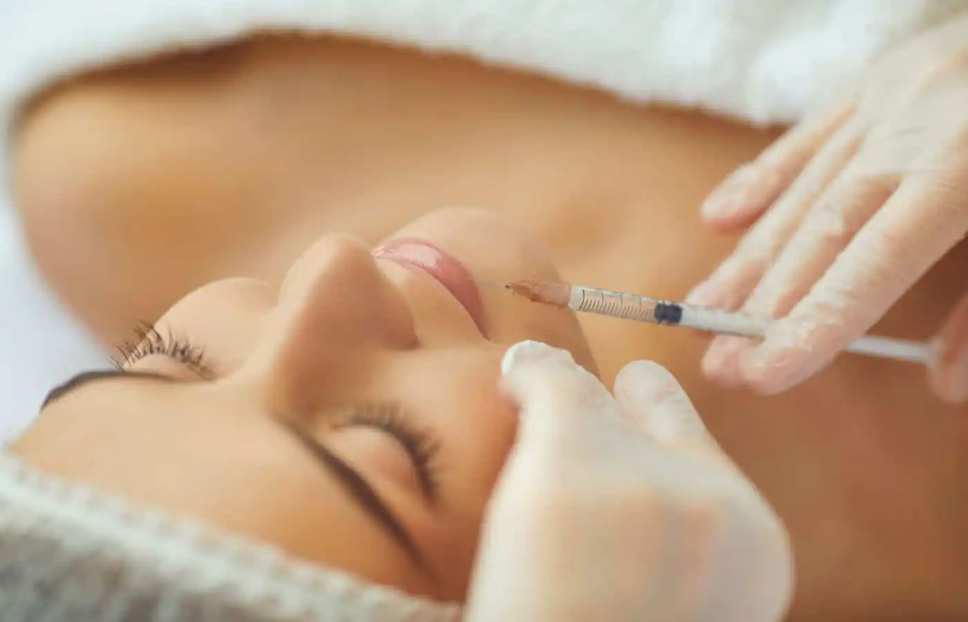 Woman receiving lip filler into her lips at Inspire Medical Spa in South Jordan, Utah.