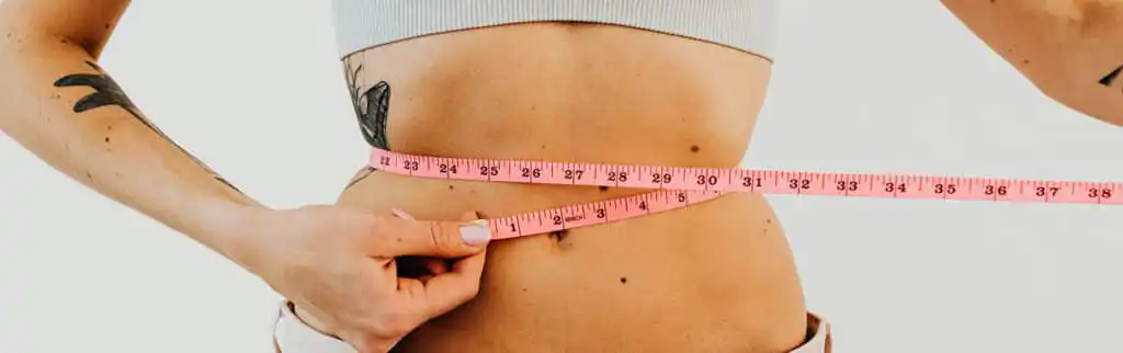 a woman with a measuring tape around her waist