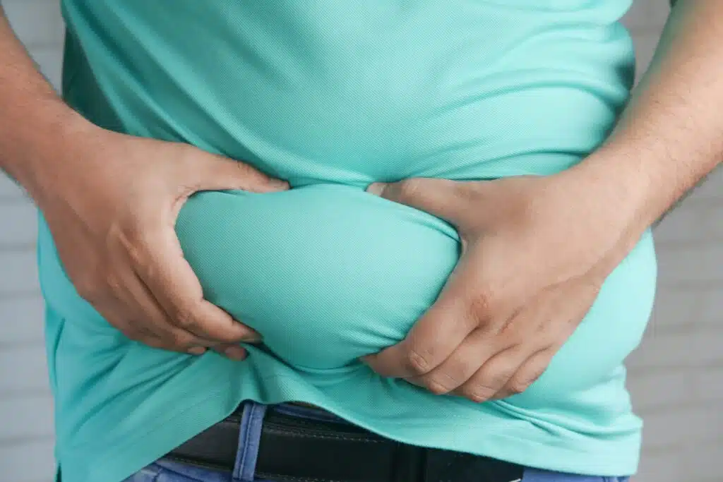 a man holding his large belly and getting ready semaglutide benefit for medical weight loss