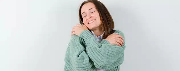 Woman hugging herself